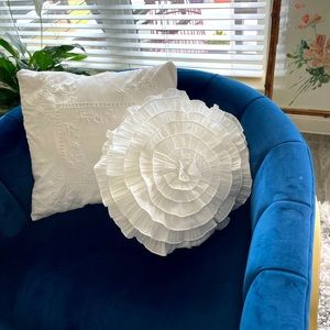 Two white throw pillows.  One round and one square.